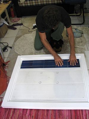 Solar panels - pressing a new row of cells.jpg